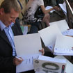 Ian Fisher signs the 10ticks materials for pupils at Bhukulone secondary school.